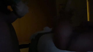 Couple on a made bed in an explicit scene