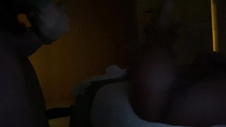 Couple on a made bed in an explicit scene