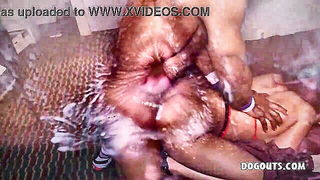 Couple on a patterned bedspread in an explicit scene