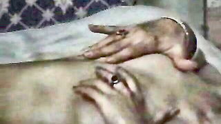 Couple on a made bed in an explicit scene