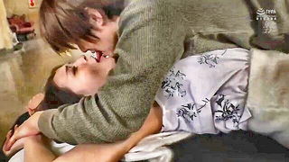 Explicit massage scene in a softly lit room