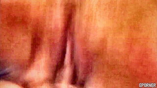 Solo performer with a toy on rumpled bedsheets