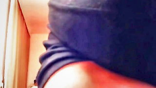 Amateur couple on a living room sofa in explicit scene