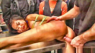 Explicit massage scene in a softly lit room