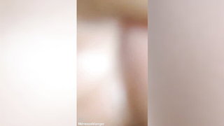 Couple mid-scene in a dim bedroom