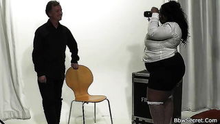Studio set with performers in an explicit scene under bright lights