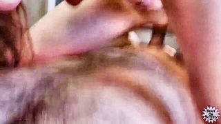 Amateur couple on a living room sofa in explicit scene