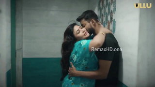 Couple mid-scene in a dim bedroom