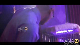 Explicit massage scene in a softly lit room