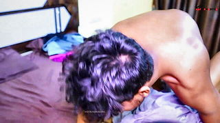 Couple on a made bed in an explicit scene
