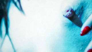 Explicit massage scene in a softly lit room