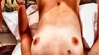 Amateur couple on a living room sofa in explicit scene