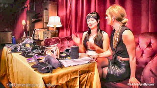 Studio set with performers in an explicit scene under bright lights