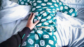 Couple on a patterned bedspread in an explicit scene