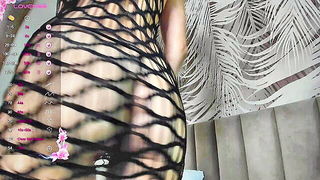 Solo performer with a toy on rumpled bedsheets