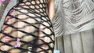 Solo performer with a toy on rumpled bedsheets