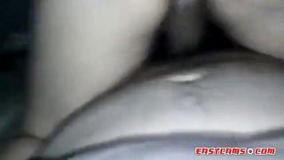 Amateur couple on a living room sofa in explicit scene