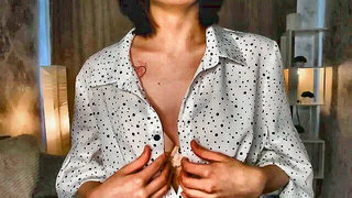 Solo performer with a toy on rumpled bedsheets