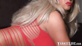 Solo performer with a toy on rumpled bedsheets