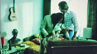 Couple on a patterned bedspread in an explicit scene