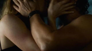 Couple on a made bed in an explicit scene