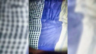 Couple on a patterned bedspread in an explicit scene