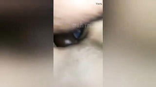 Couple on a made bed in an explicit scene
