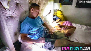Couple mid-scene in a dim bedroom