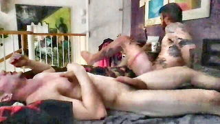 Couple on a made bed in an explicit scene