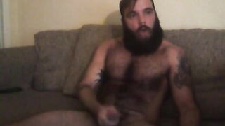 Couple on a patterned bedspread in an explicit scene