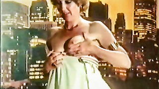Solo performer with a toy on rumpled bedsheets