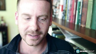 Explicit massage scene in a softly lit room