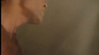 Couple on a made bed in an explicit scene