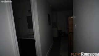 Couple mid-scene in a dim bedroom