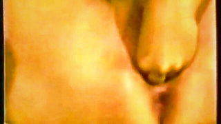 Explicit massage scene in a softly lit room