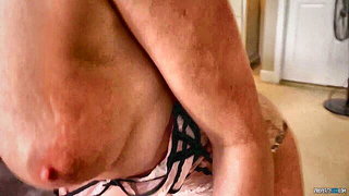 Explicit massage scene in a softly lit room