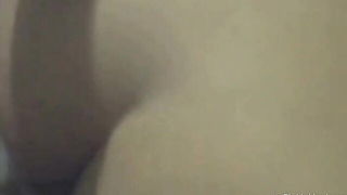 Couple mid-scene in a dim bedroom