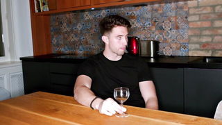 Couple on a made bed in an explicit scene