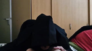 Solo performer with a toy on rumpled bedsheets