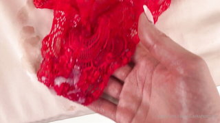 Solo performer with a toy on rumpled bedsheets