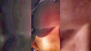 Explicit massage scene in a softly lit room
