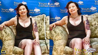 Solo performer with a toy on rumpled bedsheets