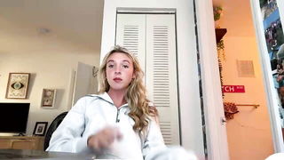 Solo performer with a toy on rumpled bedsheets