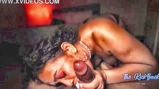 Couple on a patterned bedspread in an explicit scene