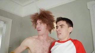 Couple on a made bed in an explicit scene