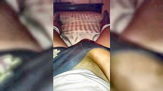Couple mid-scene in a dim bedroom