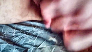 Couple on a patterned bedspread in an explicit scene
