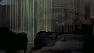 Couple on a made bed in an explicit scene