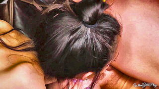 Couple on a made bed in an explicit scene