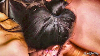 Couple on a made bed in an explicit scene